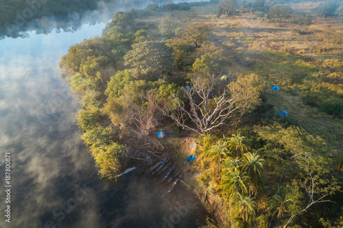 Acampados nas margens do rio Cubango de madrugada. Visto do ar com drone. Angola photo