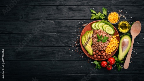 Healthy food. Buckwheat, avocado, cucumber, corn and hazelnut. On a wooden background. Top view. Free space for your text.
