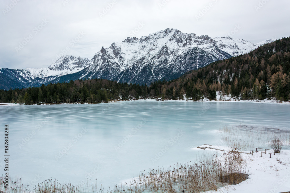 The frozen lake Lautersee near Mittenwald with snowy mountains