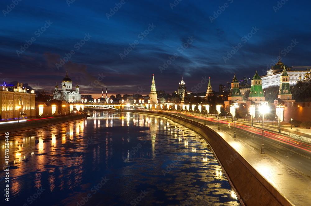Moscow Kremlin on a winter evening. The view from the Moskvoretsky bridge on the Moscow River and the Kremlin embankment, Russia