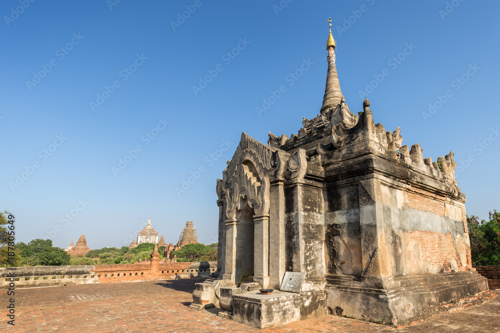 Old and small Mimalaung Kyaung Temple in Bagan, Myanmar (Burma) on a sunny day. Thatbyinnyu and other temples and pagodas are in the background.