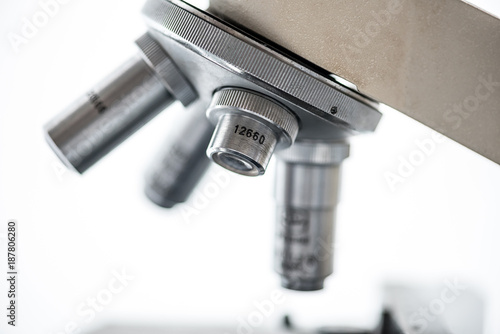 close up of microscope len on white background
