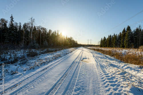 car tire tracks on winter road