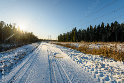 car tire tracks on winter road