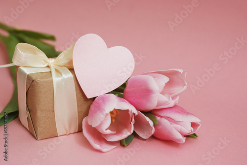 Bouquet of Pink Tulip Flower for Mother's Day or Valentine's Day or Women's Day on Pink Background with Heart. Copy Space. © Inga