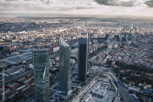 Madrid Skyline at sunset with some emblematic buildings such as Kio Towers, part of the Cuatro Torres Business Area and also a side of Santiago Bernabeu Stadium.