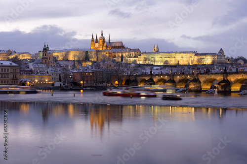 Evening colorful snowy Christmas Prague Lesser Town with gothic Castle and Charles Bridge, Czech republic