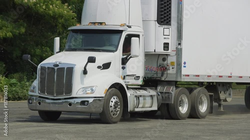 Semi truck driving at warehouse.  Fully released for commercial use.