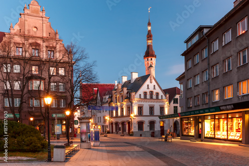 Beautiful illuminated street of Medieval Old Town and Town Hall in the morning blue hour, Tallinn, Estonia