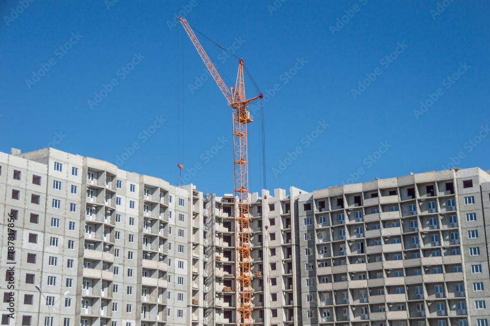Multistorey housing under construction and highrise cranes