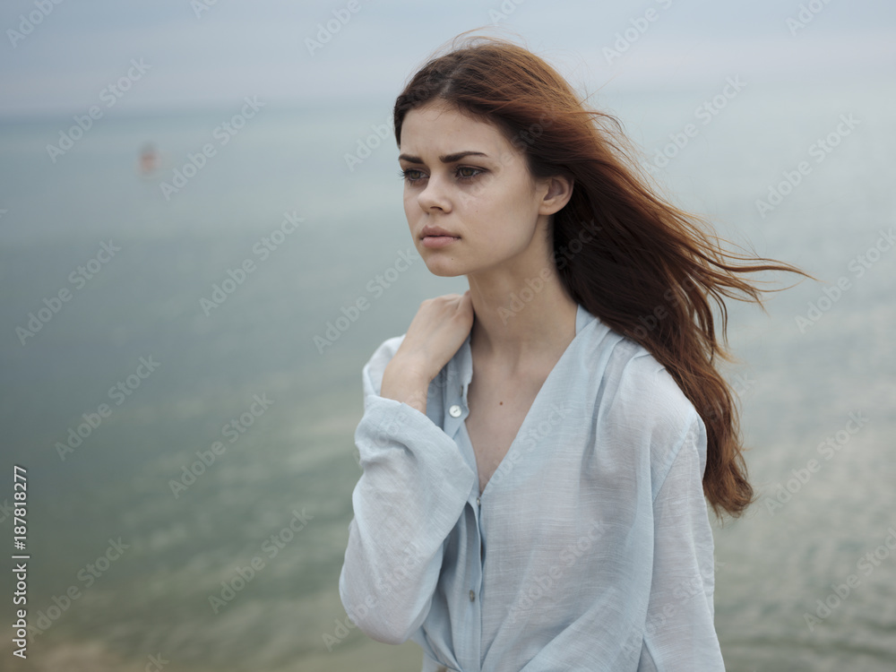 Pensive Caucasian woman standing near ocean Pensive Caucasian woman standing near ocean