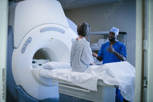 Technician talking to patient in the scanner room photo