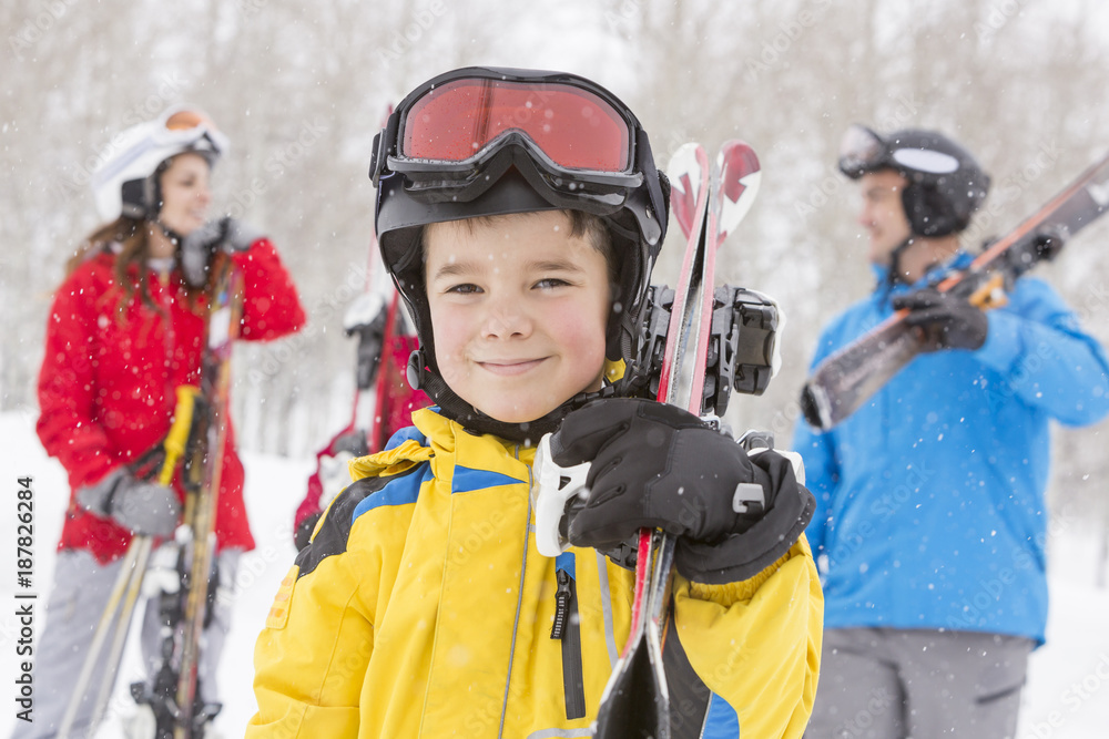 Portrait of smiling Caucasian boy carrying skis Portrait of smiling Caucasian boy carrying skis