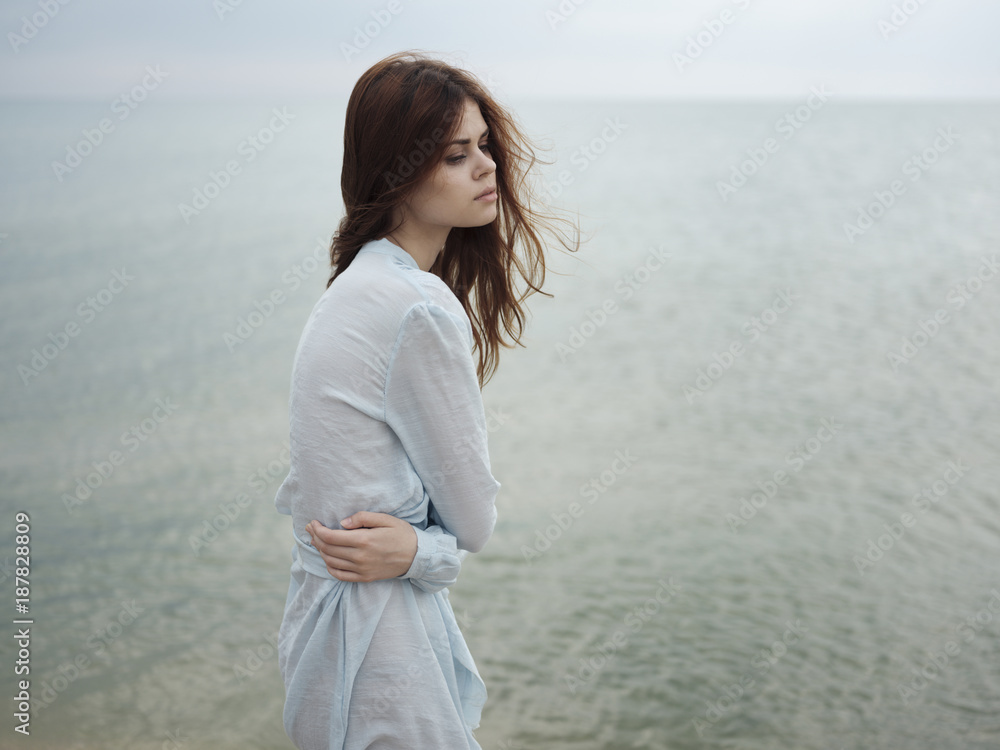 Troubled Caucasian woman standing near ocean Troubled Caucasian woman standing near ocean