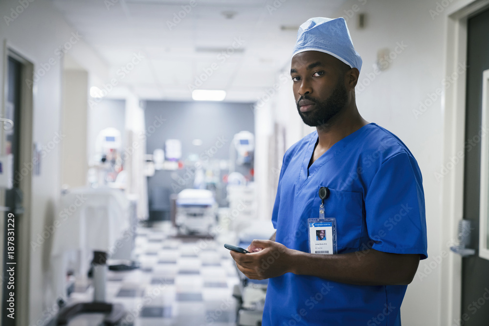 Portrait of black nurse texting on cell phone Portrait of black nurse texting on cell phone