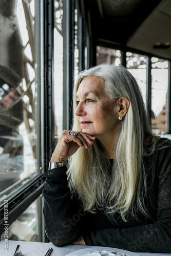 Caucasian woman admiring scenic view from restaurant window