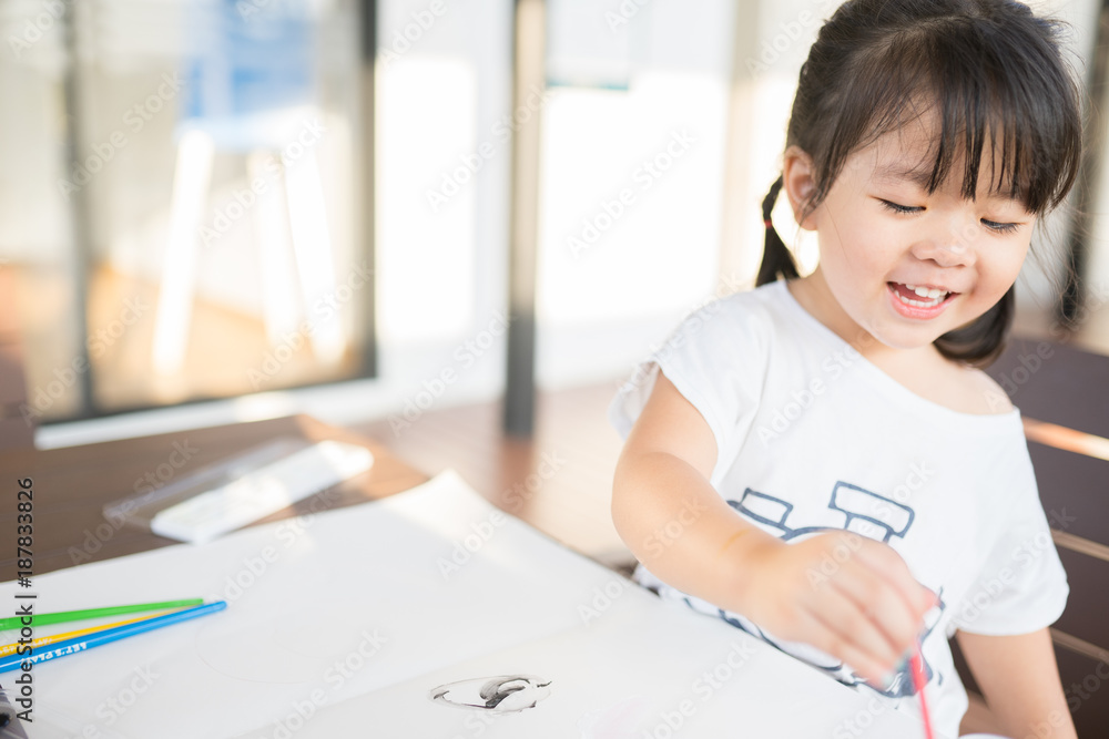 little asian girl painting with paintbrush and colorful paints little asian girl painting with paintbrush and colorful paints