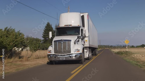 Semi truck driving on rural road.  Fully released for commercial use.