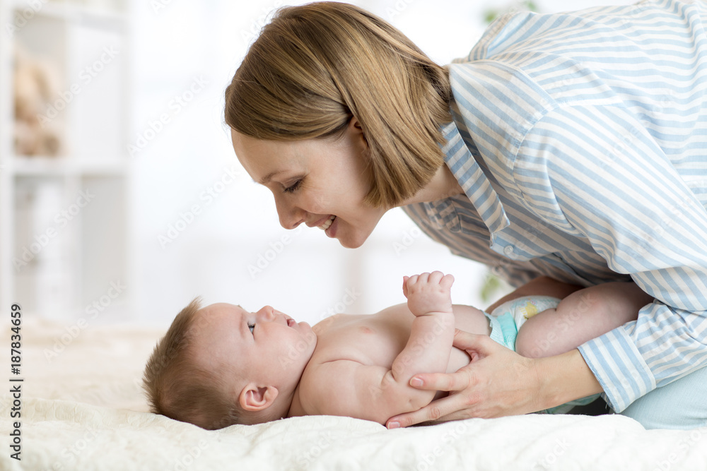 Portrait of mother and baby laughing and playing Portrait of mother and baby laughing and playing