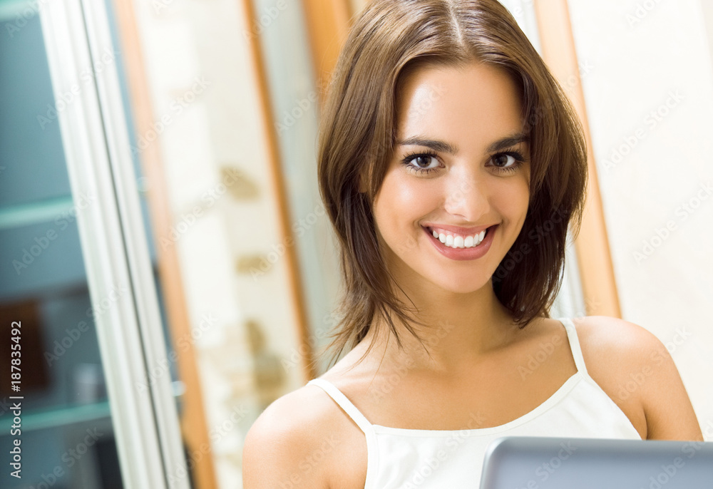 Cheerfull smiling woman working with laptop Cheerfull smiling woman working with laptop