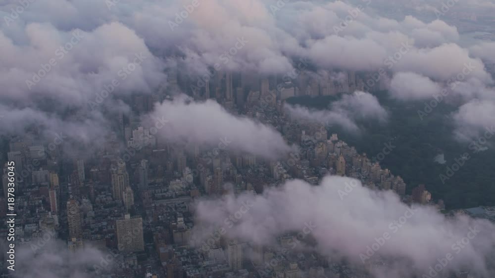 New York City circa-2017, Aerial view of Central Park and Manhattan through clouds. Shot with Cineflex and RED Epic-W Helium. New York City circa-2017, Aerial view of Central Park and Manhattan through clouds. Shot with Cineflex and RED Epic-W Helium.