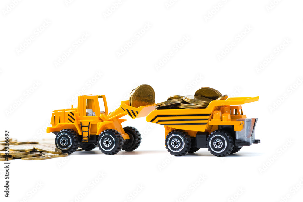 Mini bulldozer truck loading stack coin with pile of gold coin, isolated on white background with copy space, business finance and banking industrial concept.