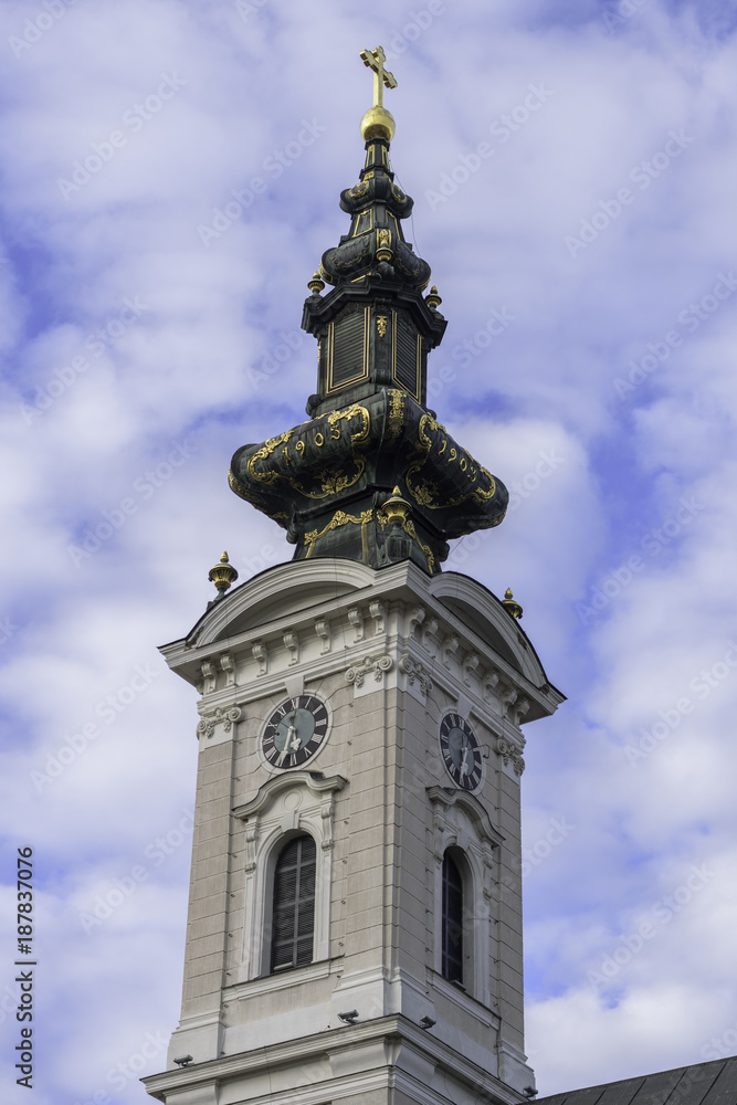 Church tower of Saint George's Cathedral in city of Novi Sad, Serbia against blue sky and clouds Church tower of Saint George's Cathedral in city of Novi Sad, Serbia against blue sky and clouds