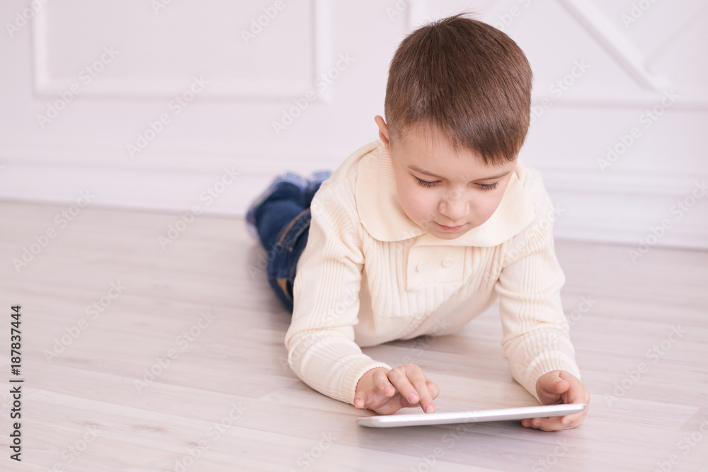 Cute boy. Computer tablet. light interior. Training Cute boy. Computer tablet. light interior. Training