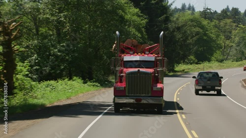 Logging truck driving on highway in Oregon forest