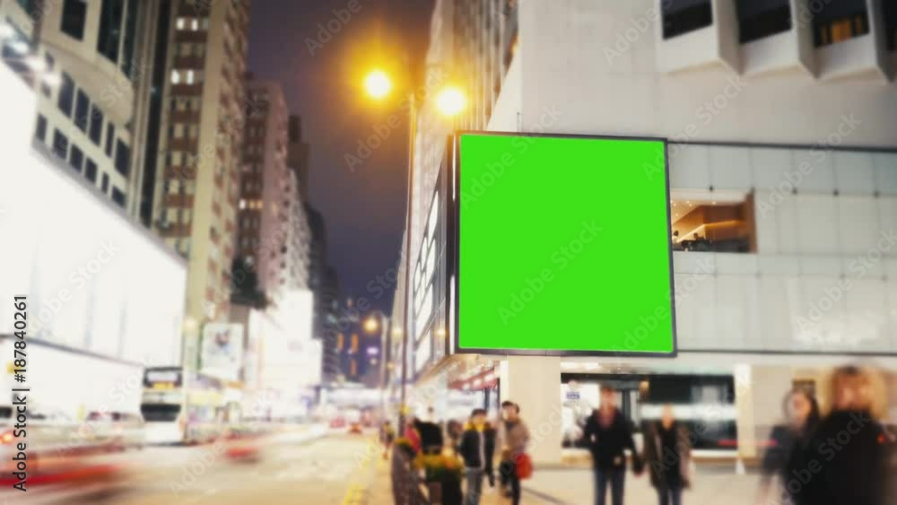 A Billboard with a Green Screen on a Evening Streets of Hong Kong .Time Lapse A Billboard with a Green Screen on a Evening Streets of Hong Kong .Time Lapse