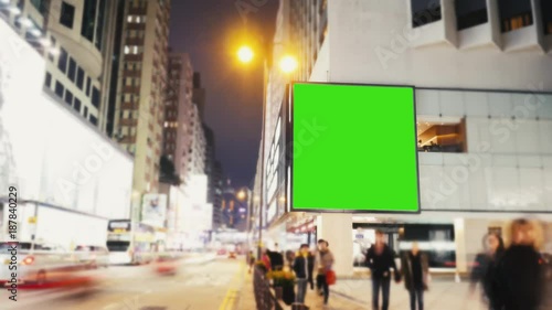 A Billboard with a Green Screen on a Evening Streets of Hong Kong .Time Lapse 