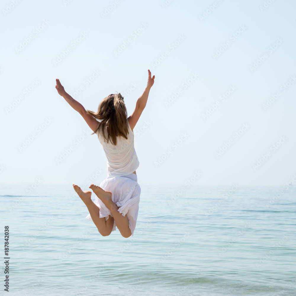 Happy beautiful young girl jumping Happy beautiful young girl jumping
