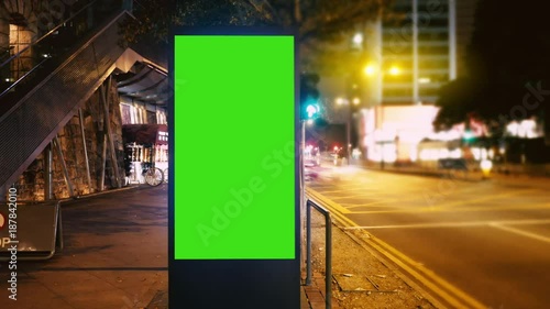A Billboard with a Green Screen on a Evening Streets of Hong Kong .Time Lapse 