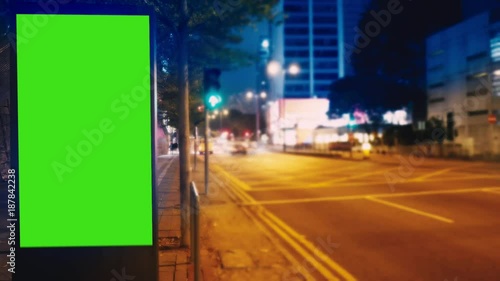 A Billboard with a Green Screen on a Evening Streets of Hong Kong .Time Lapse 