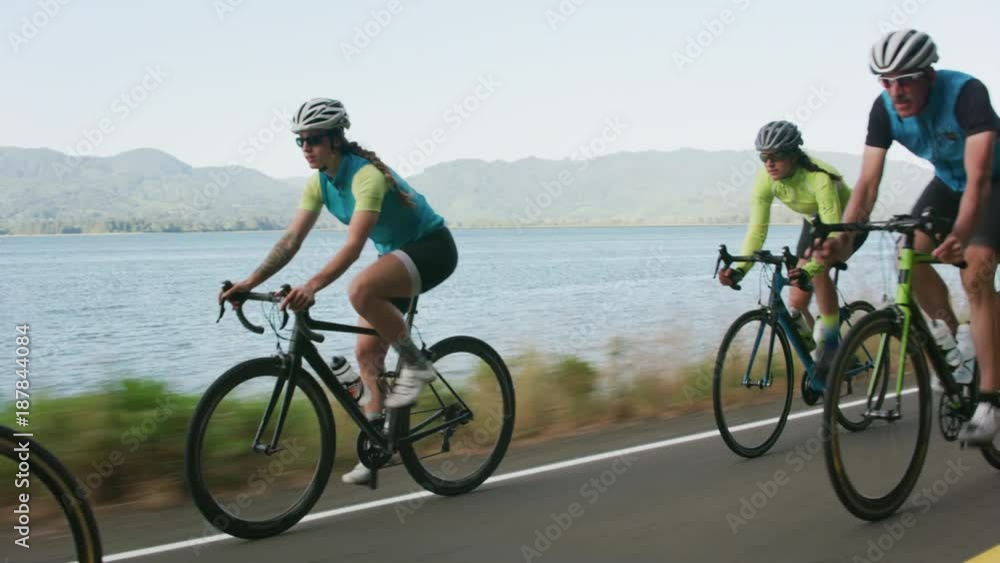 Tracking shot of a group of cyclists on country road.  Fully released for commercial use.