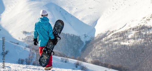 Photography snowboarder girl standing with snowboard,