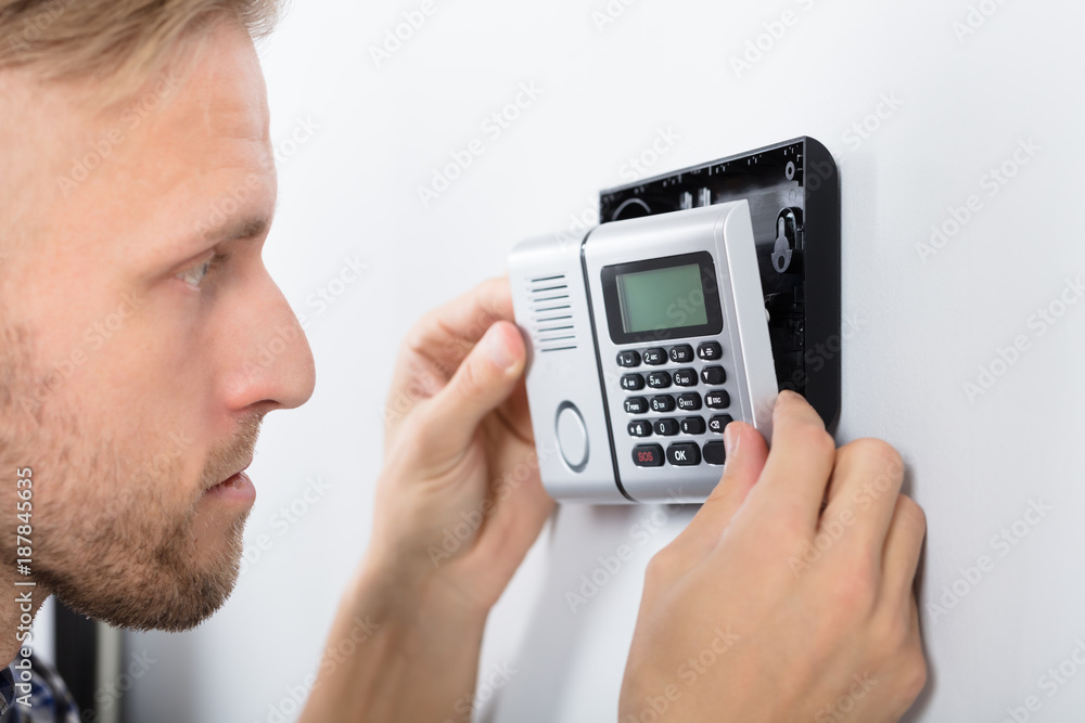 Repairman Installing Security System Repairman Installing Security System