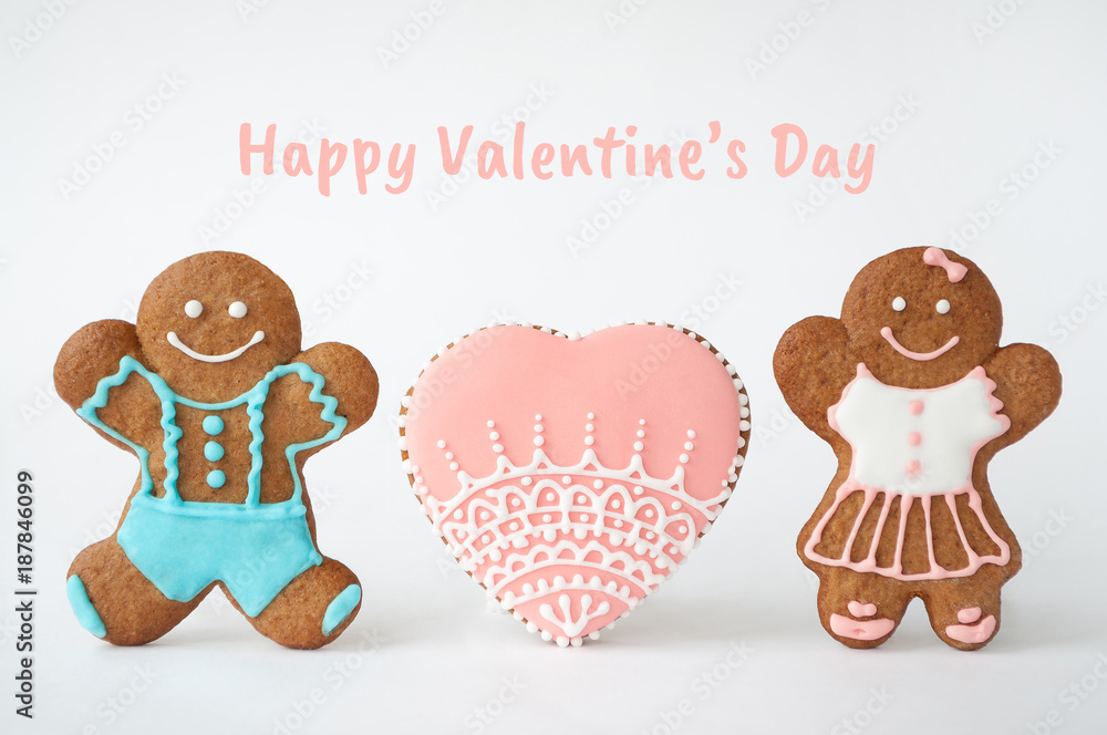 Happy Valentine`s day. Homemade gingerbread man. Boy, girl and heart. Concept of love. Picture for a menu or a confectionery catalog. Invitation or greeting card with copy space.