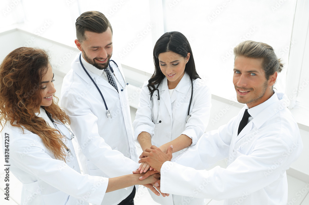 medical team with hands clasped together medical team with hands clasped together