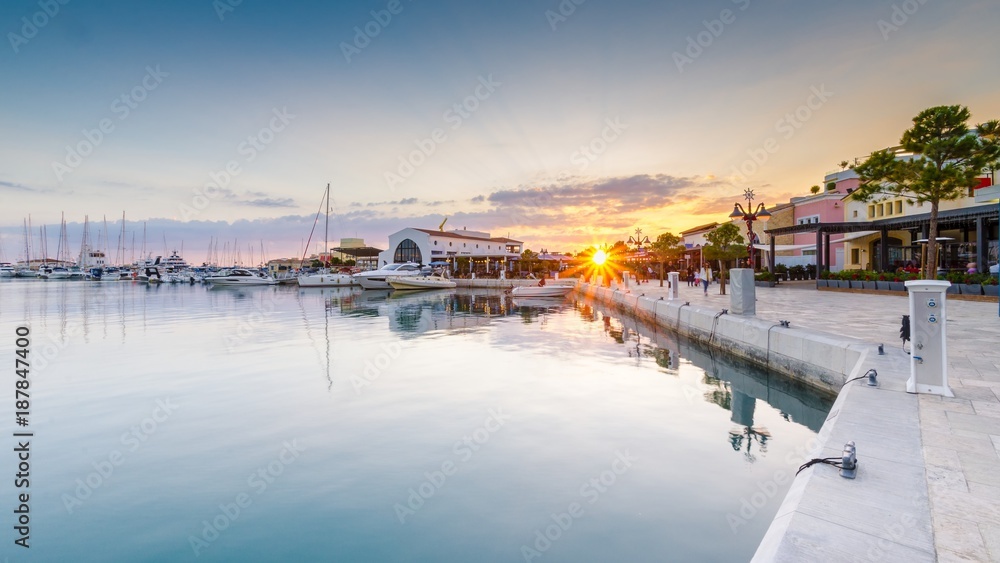 Beautiful Marina, Limassol city Cyprus. Modern, high end life in newly developed port with docked yachts, restaurants, shops, a landmark for waterfront promenade. View of the commercial area at sunset Beautiful Marina, Limassol city Cyprus. Modern, high end life in newly developed port with docked yachts, restaurants, shops, a landmark for waterfront promenade. View of the commercial area at sunset