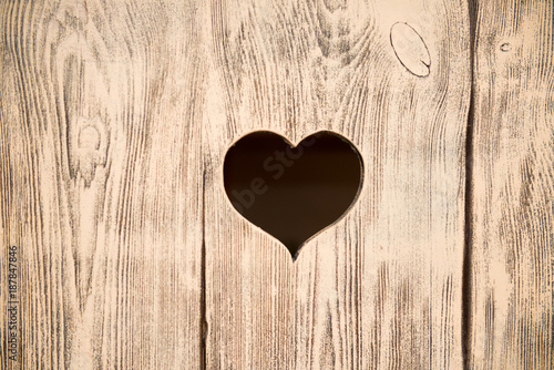 Heart carved in a wooden board. Background.