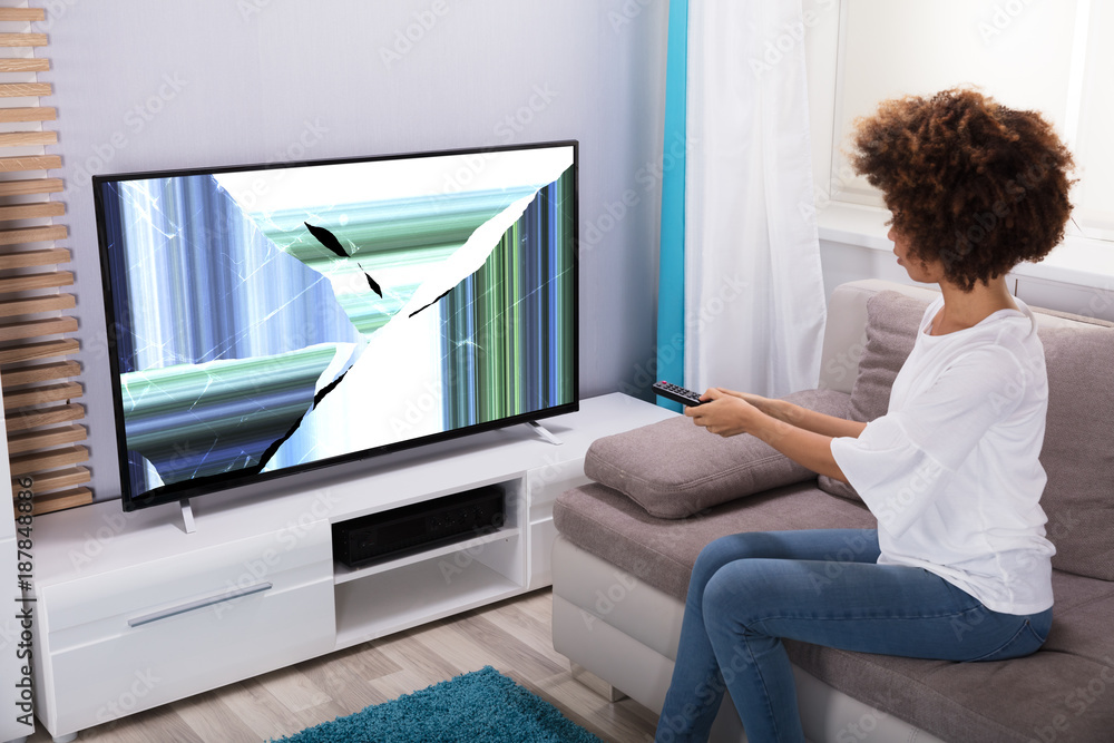 Woman Sitting Near Television Showing Distorted Screen Woman Sitting Near Television Showing Distorted Screen
