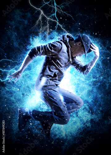 Man break dancing on electricity light background