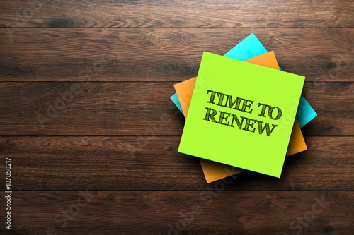 Time To Renew, the phrase is written on multi-colored stickers, on a brown wooden background. Business concept, strategy, plan, planning.