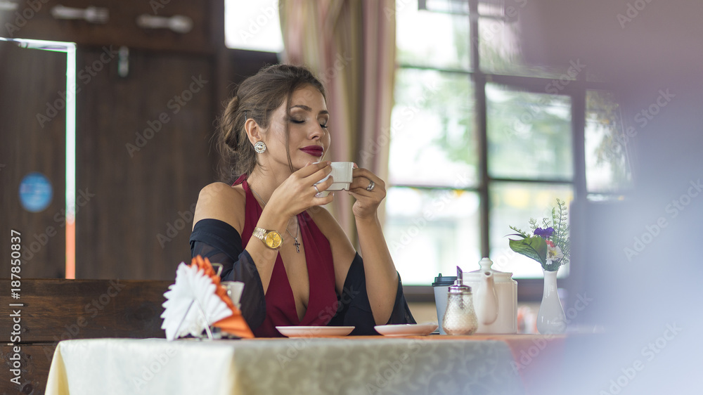 Attractive stylish female drinking tea from cup Attractive stylish female drinking tea from cup