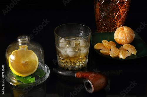 Glass of whiskey with a Smoking pipe and a decanter photo