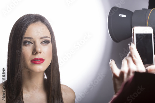 photo session with phone of beauty make up model.celebration © arizanko