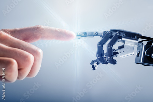 Businessperson's Finger Touching Robotic Finger
