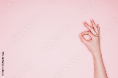 cropped shot of woman showing okay sign isolated on pink © LIGHTFIELD STUDIOS