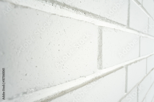White painted brick wall at an angle. Potential use as a background with copy space on bricks. photo